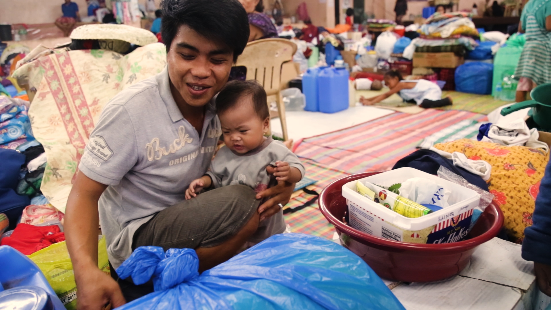 A dad, a baby, and an evacuation center